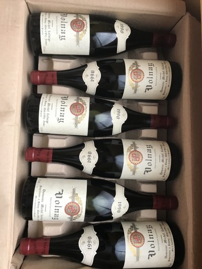 Lot 41:  Michel Lafarge Volnay 1990 (12 bottles in OC) Provenance: Recently removed from a damp French country house cellar. Levels: 9x1cm, 3x1.5cm. Excellet appearance.