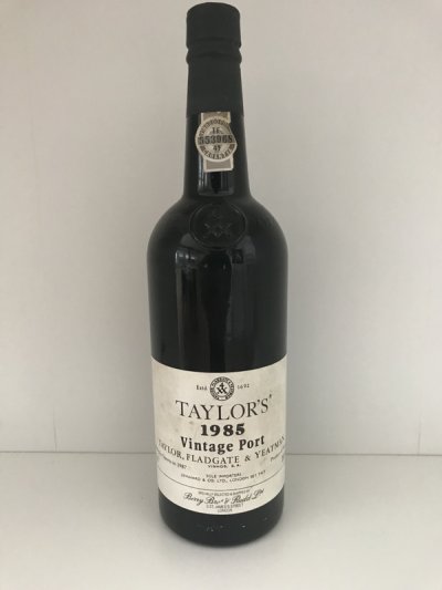 Lot 70:  Taylor Vintage Port 1985 (3 bottles) Recently removed from a London cellar. Provenance: Berry Bros. and Rudd. Excellent appearance and levels.